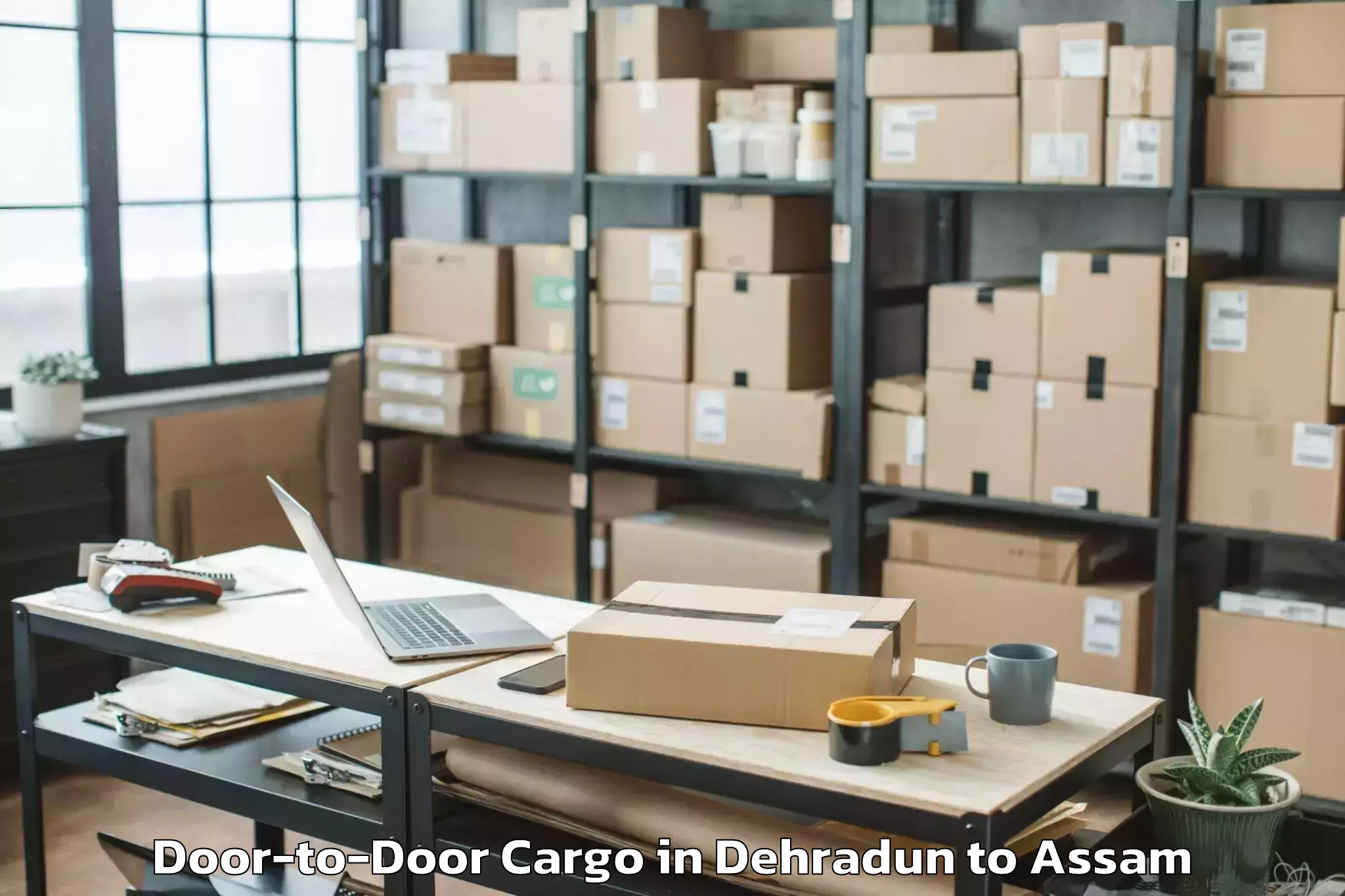 Book Dehradun to Salonibari Airport Tez Door To Door Cargo Online